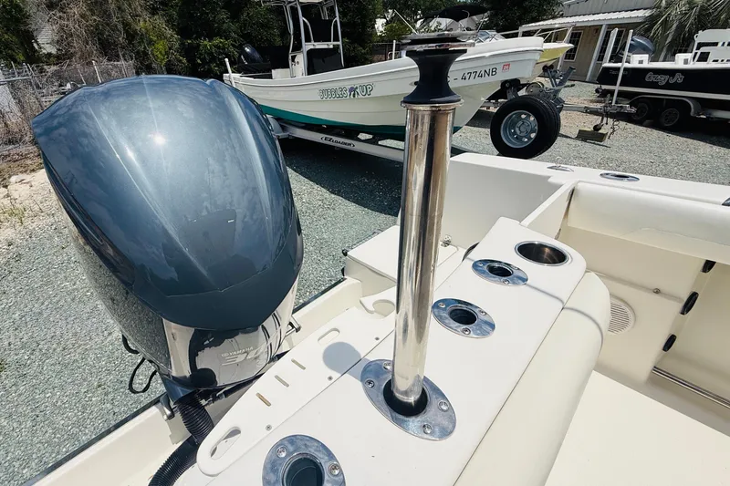 Slide: The Image of 2015 Sailfish 240 CC boat with Yamaha outboard motor and rod holders. - 12