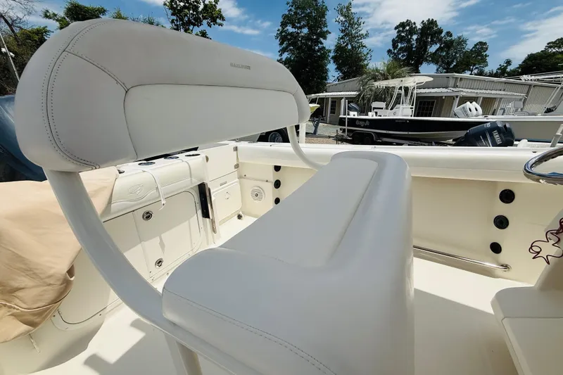 Slide: The Image of 2015 Sailfish 240 CC boat interior with white seating and control panel. - 14