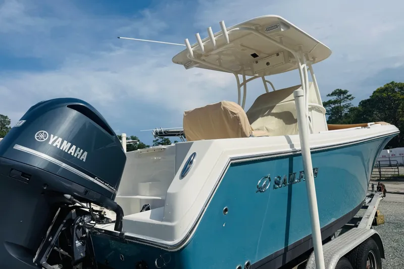 Slide: The Image of 2015 Sailfish 240 CC boat with Yamaha engine on trailer, under clear sky. - 4