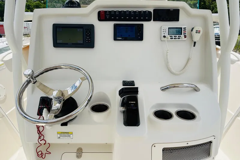 Slide: The Image of 2015 Sailfish 240 CC boat dashboard with steering wheel and navigation controls. - 6