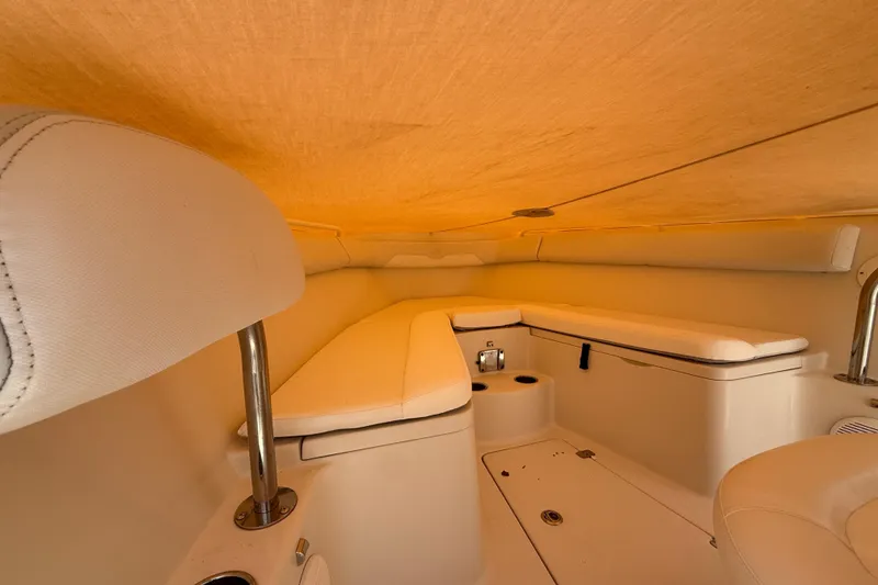 Slide: The Image of Interior cabin of a 2015 Sailfish 240 CC boat with cushioned seating. - 9