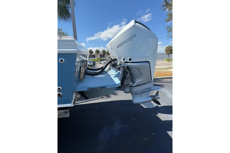 Slide: The Image of 2005 Bluewater 2850 CC boat with Mercury outboard motor, parked outdoors. - 4