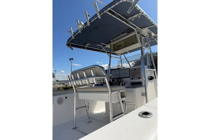 Slide: The Image of 2005 Bluewater 2850 CC boat interior with helm and seating under a canopy. - 7