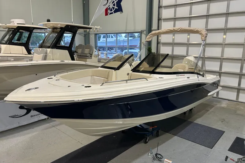 The Image of 2026 Scout 220 Dorado boat displayed in a showroom, featuring sleek design and modern amenities. - 0
