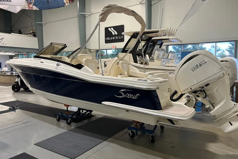 Slide: The Image of 2026 Scout 220 Dorado boat with Yamaha engine displayed indoors. - 1