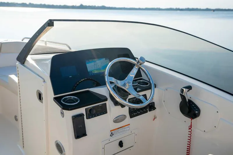 Slide: The Image of Manufacturer Provided Image: 2026 Scout 220 Dorado boat dashboard with steering wheel and navigation system. - 17