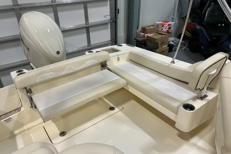 Slide: The Image of 2026 Scout 220 Dorado boat interior with white seating and Yamaha engine. - 2