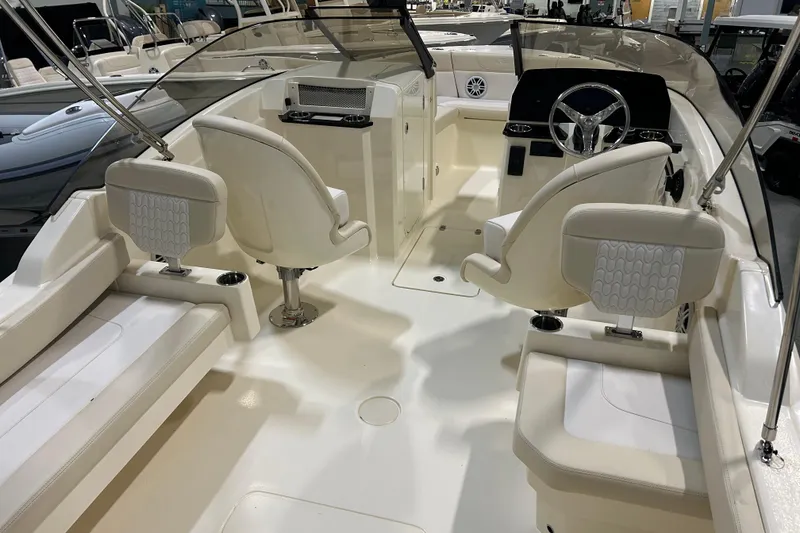 Slide: The Image of 2026 Scout 220 Dorado boat interior with white seating and modern dashboard. - 3