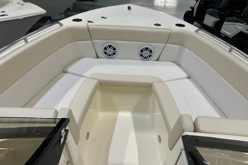 Slide: The Image of 2026 Scout 220 Dorado boat interior with beige seating and built-in speakers. - 6