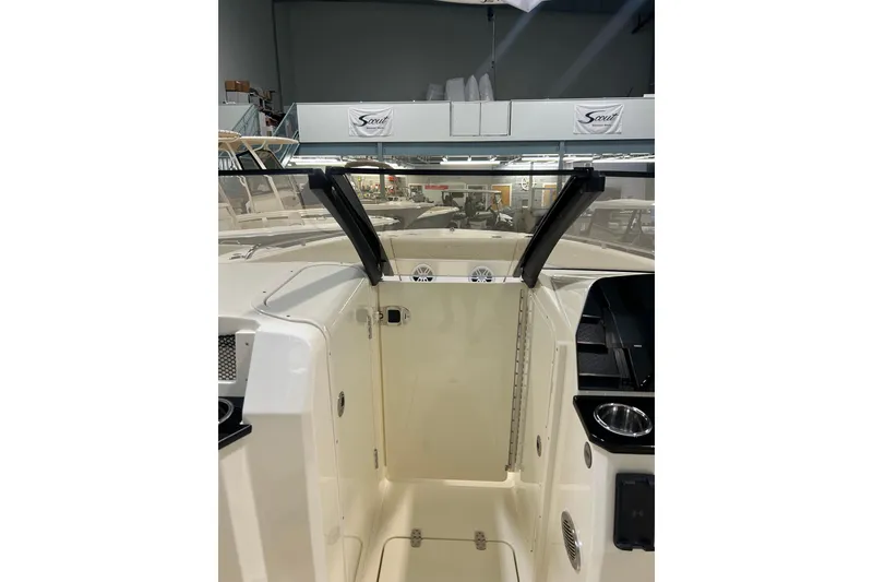 Slide: The Image of 2026 Scout 220 Dorado boat interior with open windshield and storage compartments. - 7