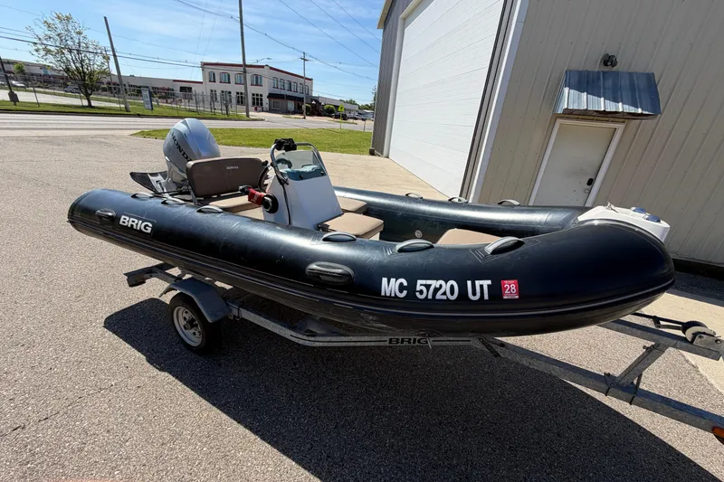 Slide: The Image of 2022 Brig Falcon 420 inflatable boat on trailer, parked outside a building. - 13