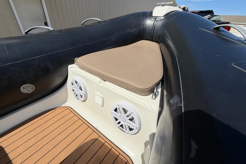 Slide: The Image of 2022 Brig Falcon 420 boat interior with cushioned seating and speakers. - 15