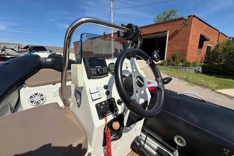 Slide: The Image of 2022 Brig Falcon 420 boat interior with steering wheel and control panel. - 19