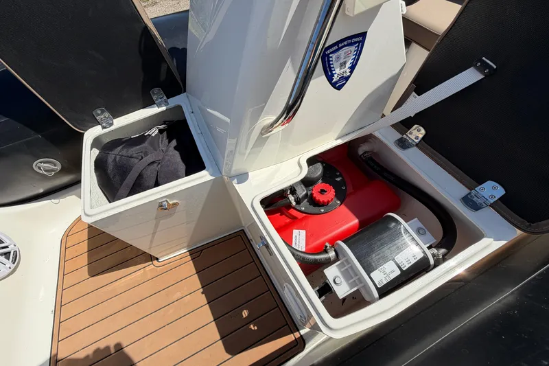 Slide: The Image of 2022 Brig Falcon 420 boat storage compartments with safety check sticker and equipment. - 21