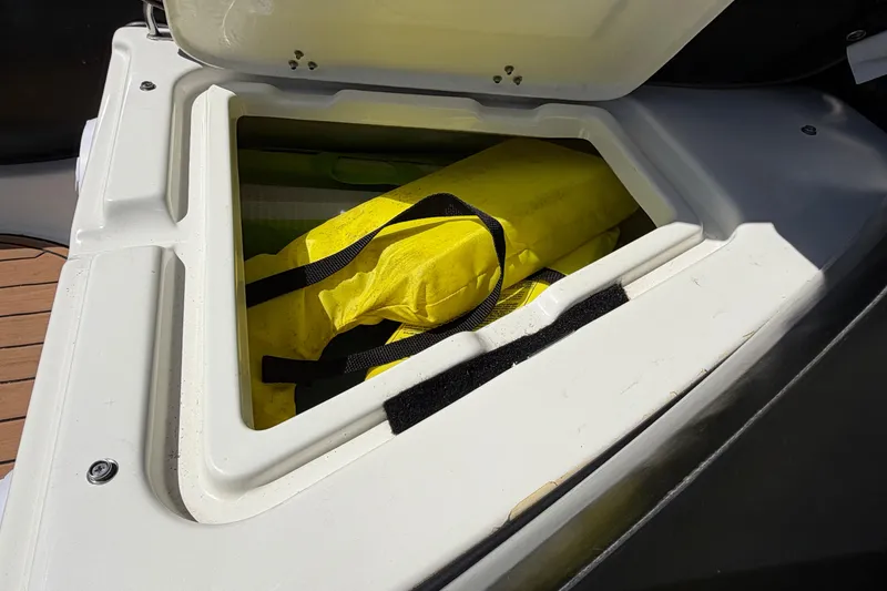 Slide: The Image of Storage compartment on a 2022 Brig Falcon 420 boat with yellow life jacket inside. - 22