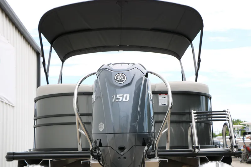 Slide: The Image of 2026 Sylvan Mirage 822 LZ pontoon boat with Yamaha 150 engine, docked outdoors. - 11