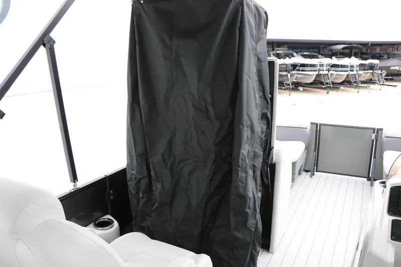 Slide: The Image of 2026 Sylvan Mirage 822 LZ boat interior with privacy curtain and seating area. - 36