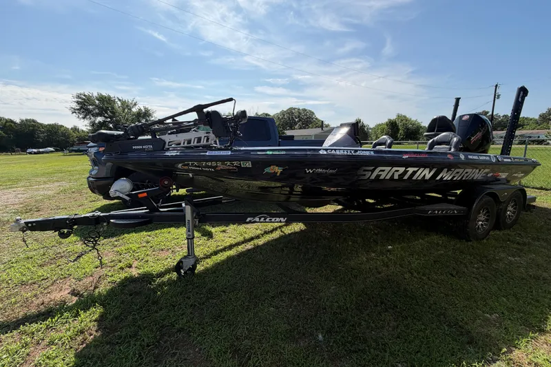 The Image of 2023 Falcon F21TE boat on trailer, parked on grass, with visible branding and equipment. - 1