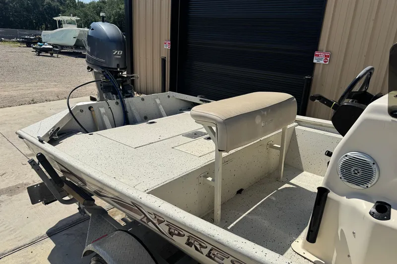Slide: The Image of 2017 Xpress XP18CC boat with Yamaha 70 engine, parked outside a garage. - 10