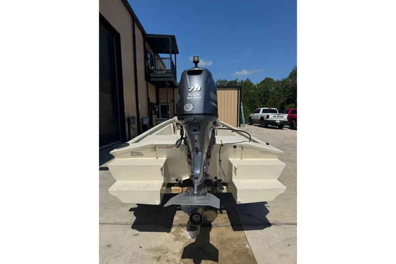 Slide: The Image of 2017 Xpress XP18CC boat with Yamaha outboard motor, parked outdoors. - 12