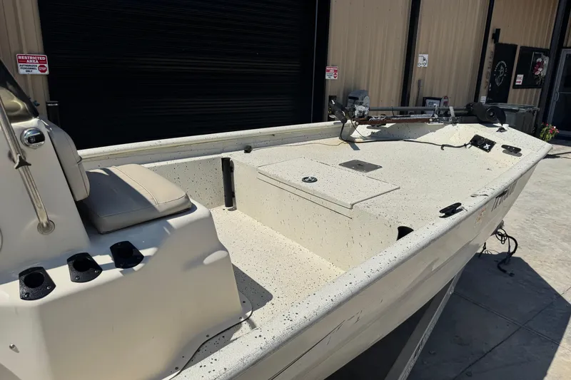 Slide: The Image of 2017 Xpress XP18CC boat with beige interior, docked near a building. - 4