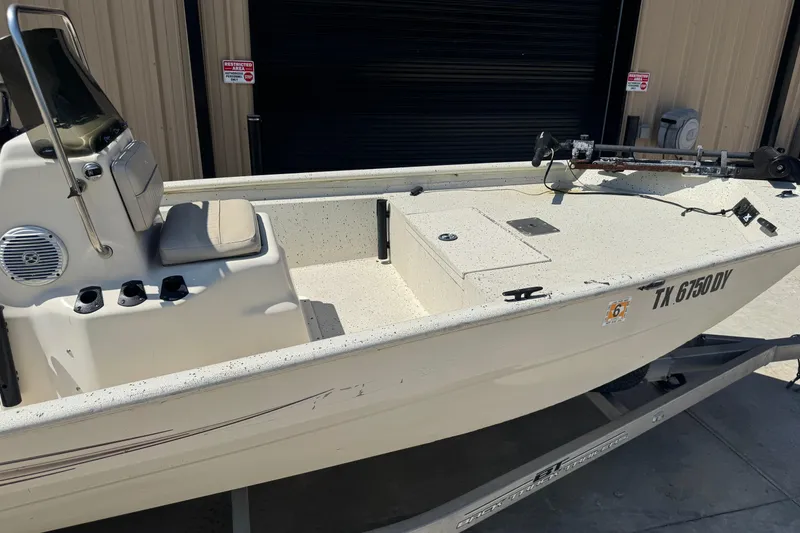 Slide: The Image of 2017 Xpress XP18CC boat on trailer, beige interior, parked outside a building. - 8