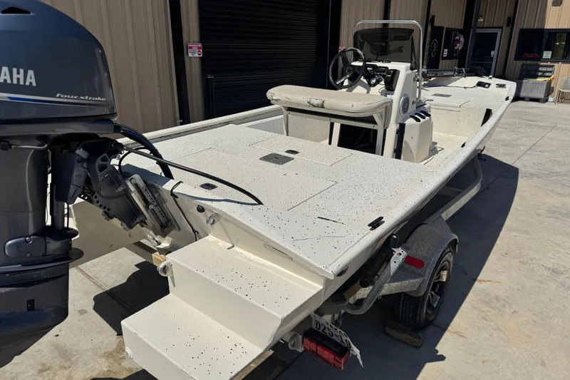 Slide: The Image of 2017 Xpress XP18CC boat with Yamaha engine on trailer, parked outside a building. - 9