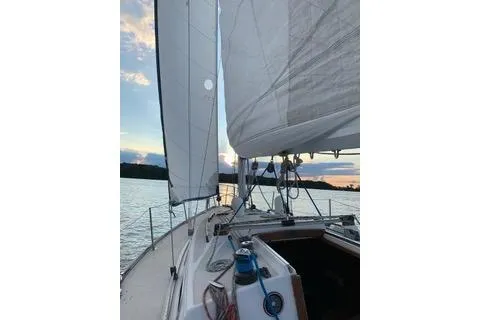 Slide: The Image of 1988 Tartan 31 sailboat on calm waters at sunset. - 3