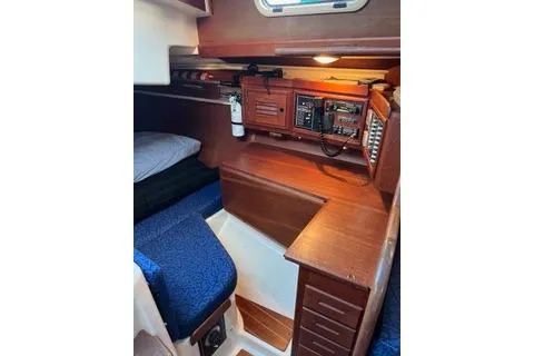 Slide: The Image of 1988 Tartan 31 yacht interior with navigation station and cozy seating area. - 7