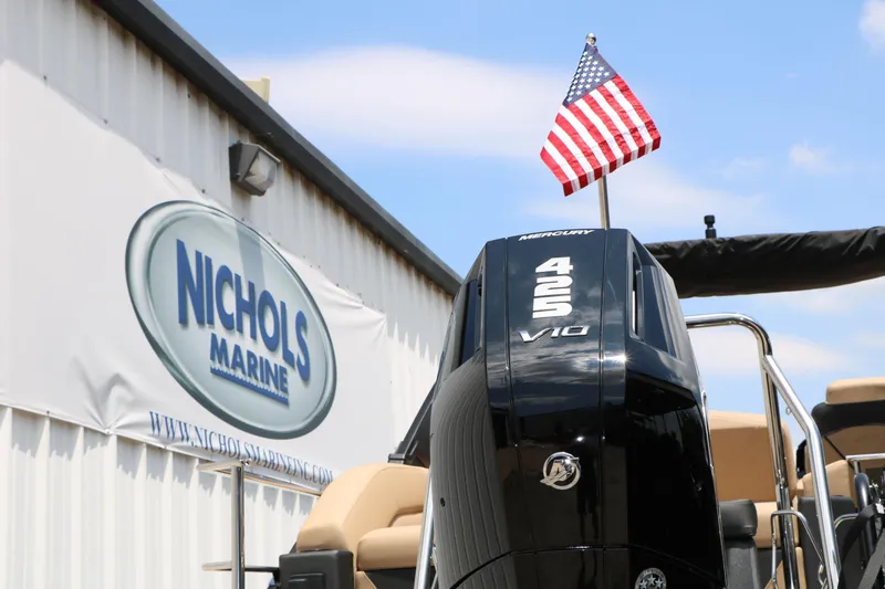 Slide: The Image of 2026 Evotti 725 CS Arch Tri-Toon boat at Nichols Marine with American flag. - 15