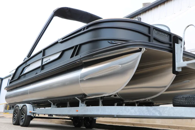Slide: The Image of 2026 Evotti 725 CS Arch Tri-Toon boat on trailer, showcasing sleek design and modern features. - 6
