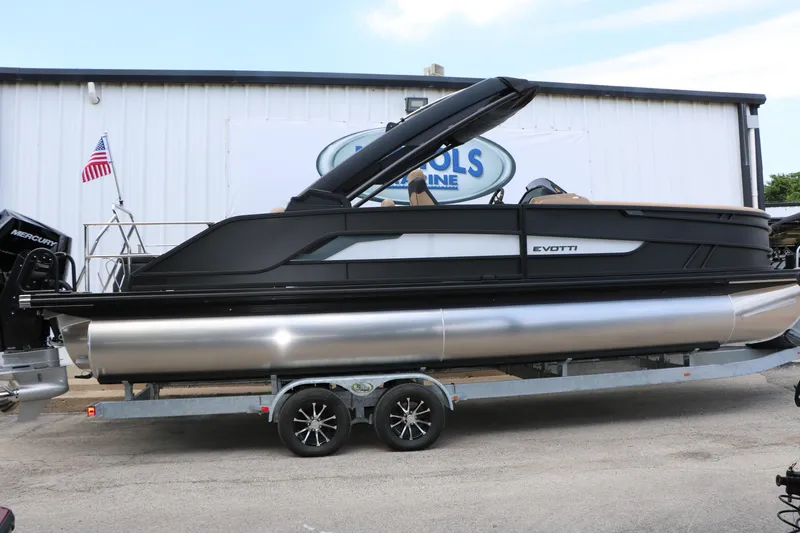 Slide: The Image of 2026 Evotti 725 CS Arch Tri-Toon boat on trailer, sleek design, parked outdoors. - 7