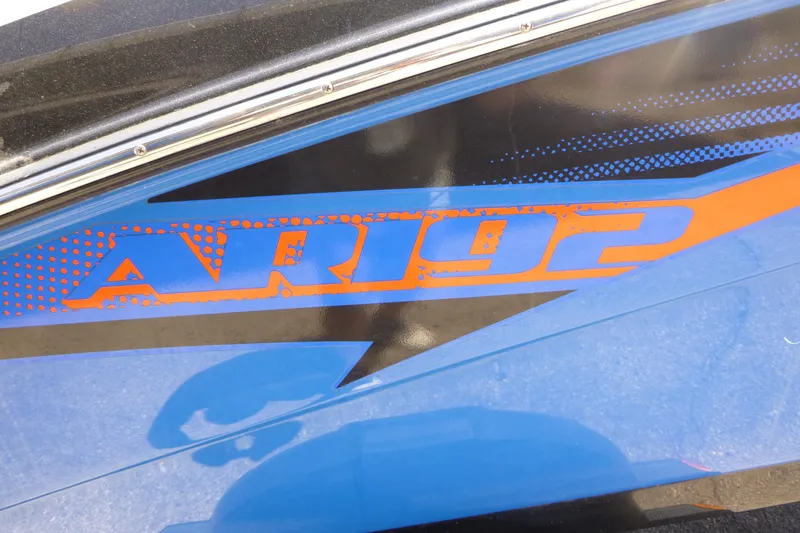 Slide: The Image of 2014 Yamaha Boats AR192 logo in blue and orange on boat exterior. - 12