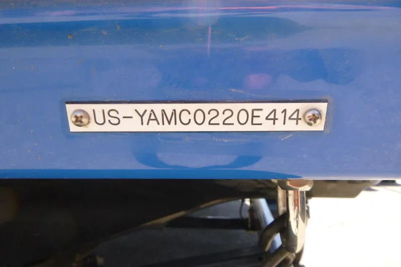 Slide: The Image of 2014 Yamaha Boats AR192 hull identification number plate on blue surface. - 13