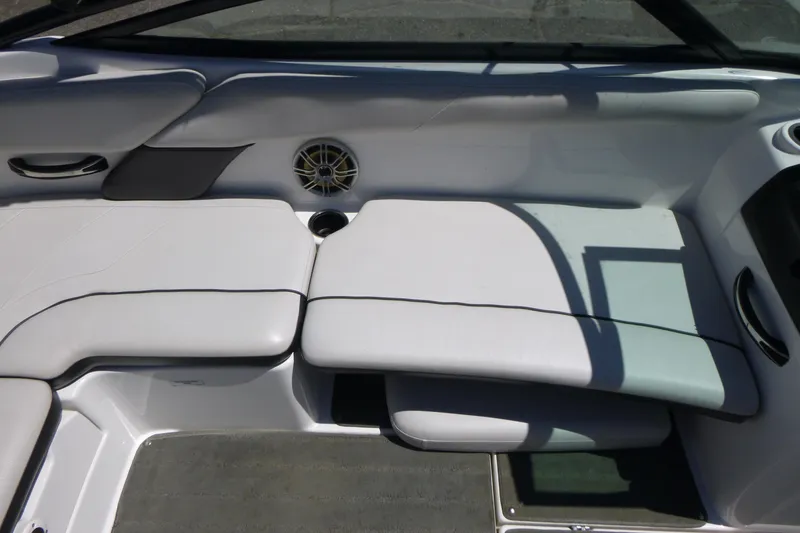 Slide: The Image of Interior seating of a 2014 Yamaha Boats AR192, featuring white upholstery and speaker. - 9