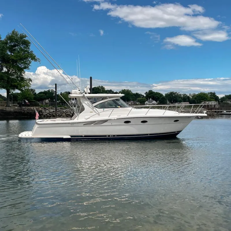 The Image of 2004 Tiara Yachts 3800 Open cruising on a calm lake under a blue sky. - 0
