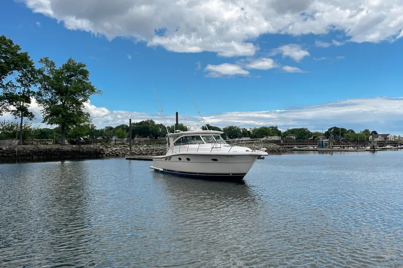 Slide: The Image of 2004 Tiara Yachts 3800 Open cruising on a calm lake under a partly cloudy sky. - 10