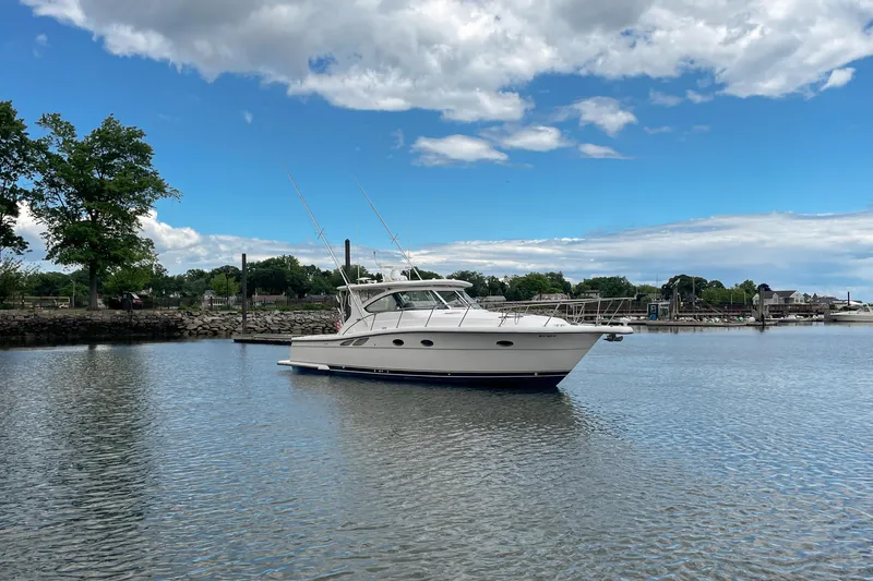 Slide: The Image of 2004 Tiara Yachts 3800 Open cruising on a calm lake under a partly cloudy sky. - 11