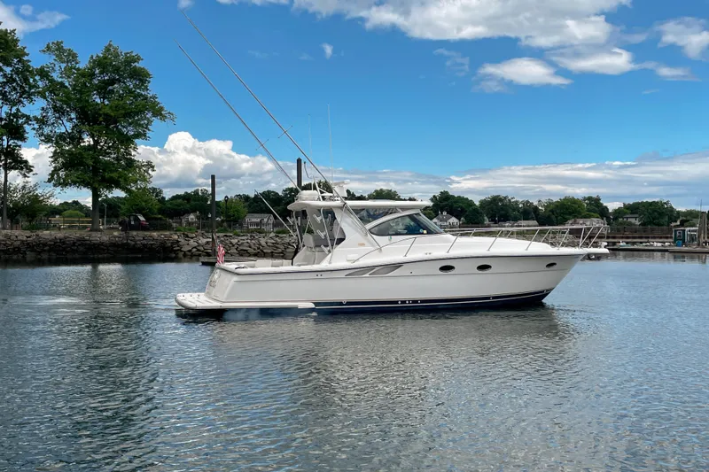 Slide: The Image of 2004 Tiara Yachts 3800 Open cruising on a calm lake under a blue sky. - 12