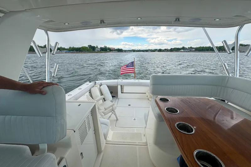 Slide: The Image of 2004 Tiara Yachts 3800 Open interior with seating, table, and water view. - 13