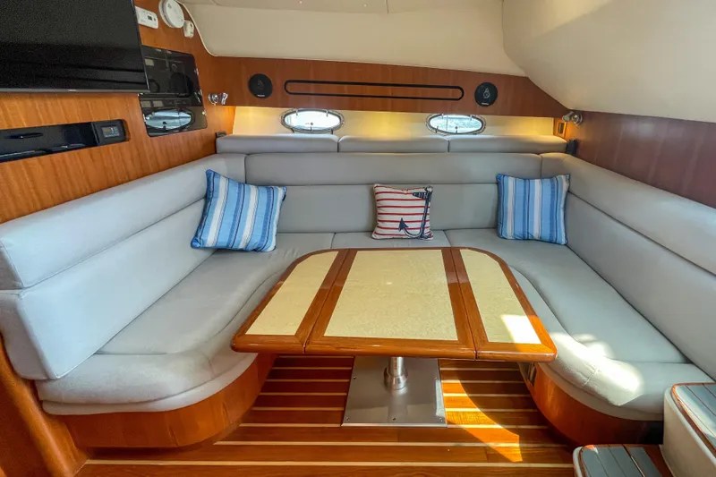 Slide: The Image of Luxurious interior of 2004 Tiara Yachts 3800 Open with elegant seating and nautical decor. - 18
