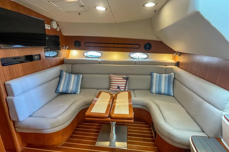 Slide: The Image of Luxurious 2004 Tiara Yachts 3800 Open interior with plush seating and elegant wood finishes. - 19