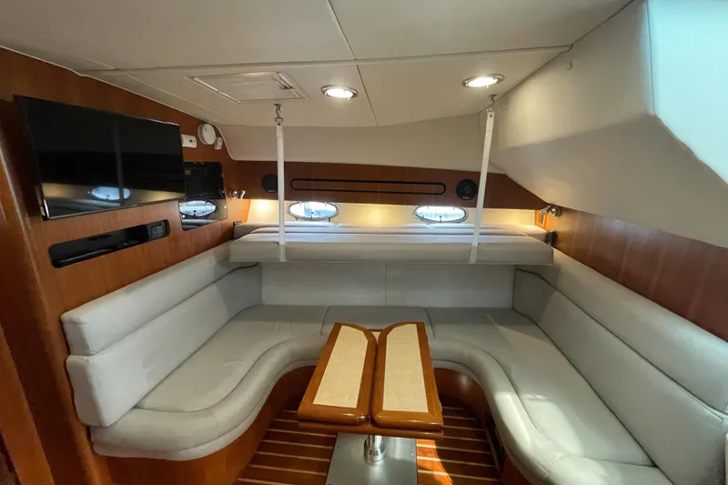 Slide: The Image of Luxurious interior of 2004 Tiara Yachts 3800 Open with plush seating and trundle bed lowered and flat screen Samsung TV. - 21