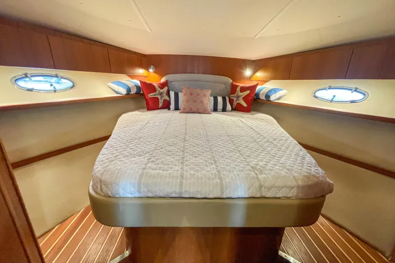 Slide: The Image of Luxurious cabin interior of 2004 Tiara Yachts 3800 Open with cozy bedding and nautical decor. - 22