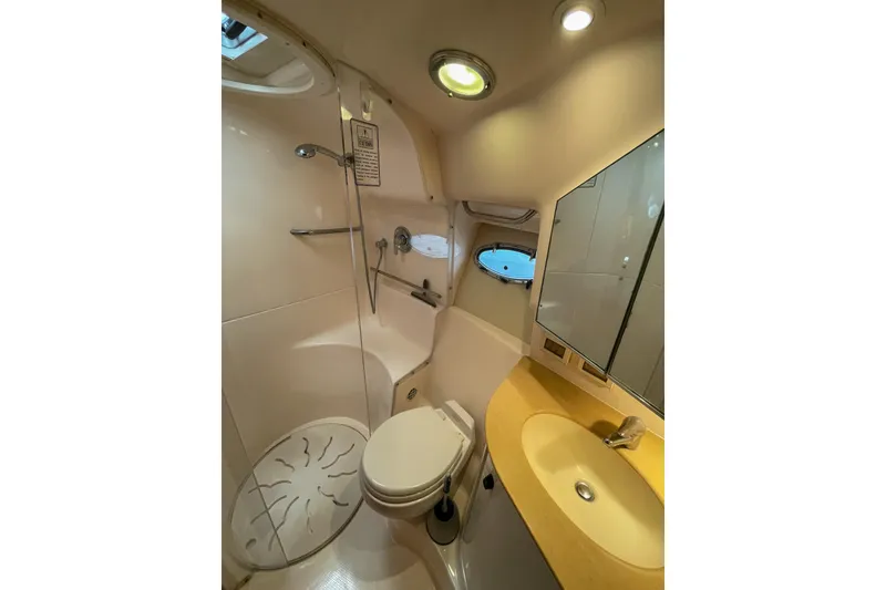 Slide: The Image of 2004 Tiara Yachts 3800 Open bathroom with shower, sink, and toilet. - 29