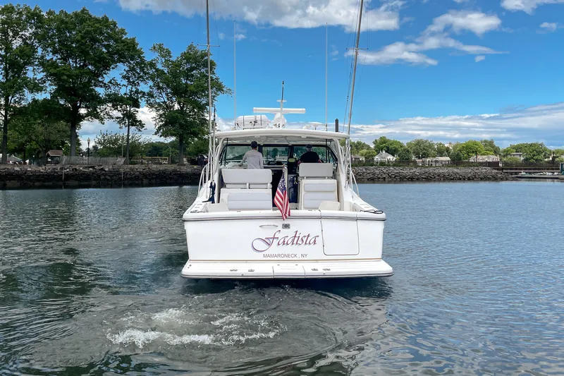 Slide: The Image of 2004 Tiara Yachts 3800 Open cruising on a calm river with scenic shoreline. - 3