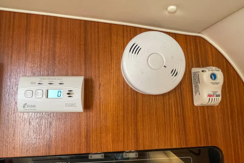Slide: The Image of Carbon monoxide and smoke detectors on 2004 Tiara Yachts 3800 Open wooden interior. - 31