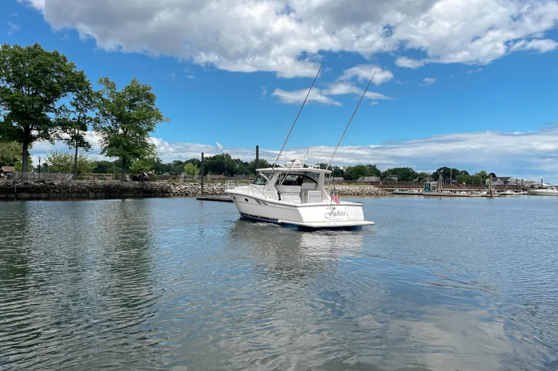 Slide: The Image of 2004 Tiara Yachts 3800 Open cruising on a calm lake under a partly cloudy sky. - 4