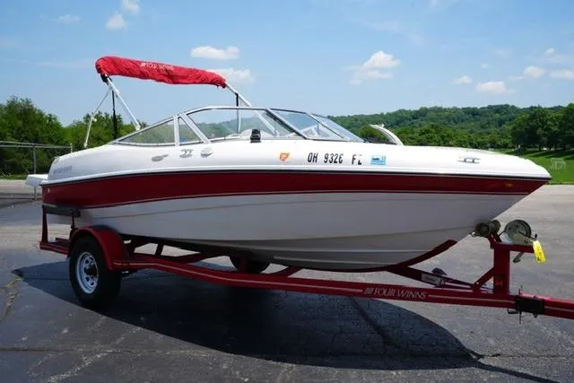 Slide: The Image of 2006 Four Winns 183 Horizon Fish & Ski boat on trailer, red and white design. - 3