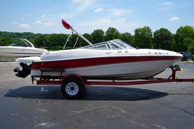 Slide: The Image of 2006 Four Winns 183 Horizon Fish & Ski boat on trailer, parked outdoors. - 4